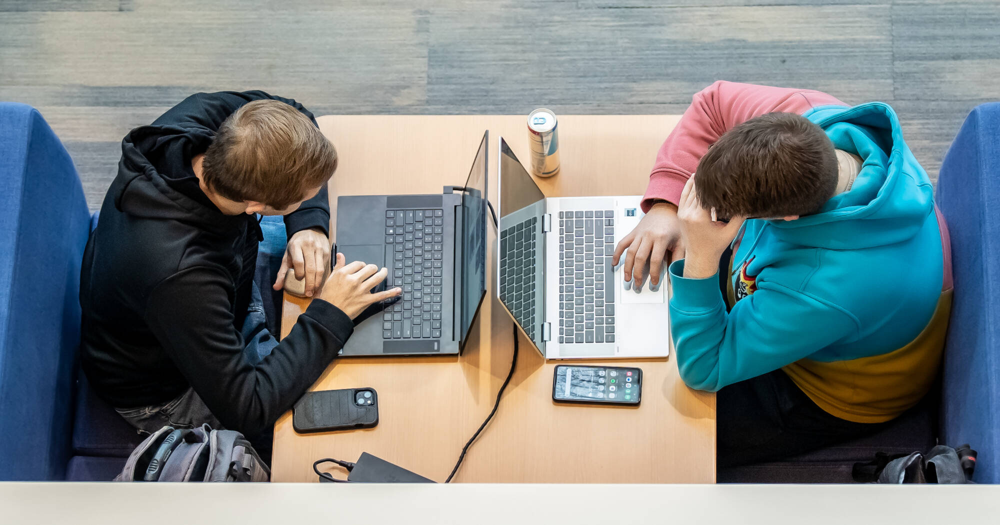 Two students are diligently preparing for final exams in library.